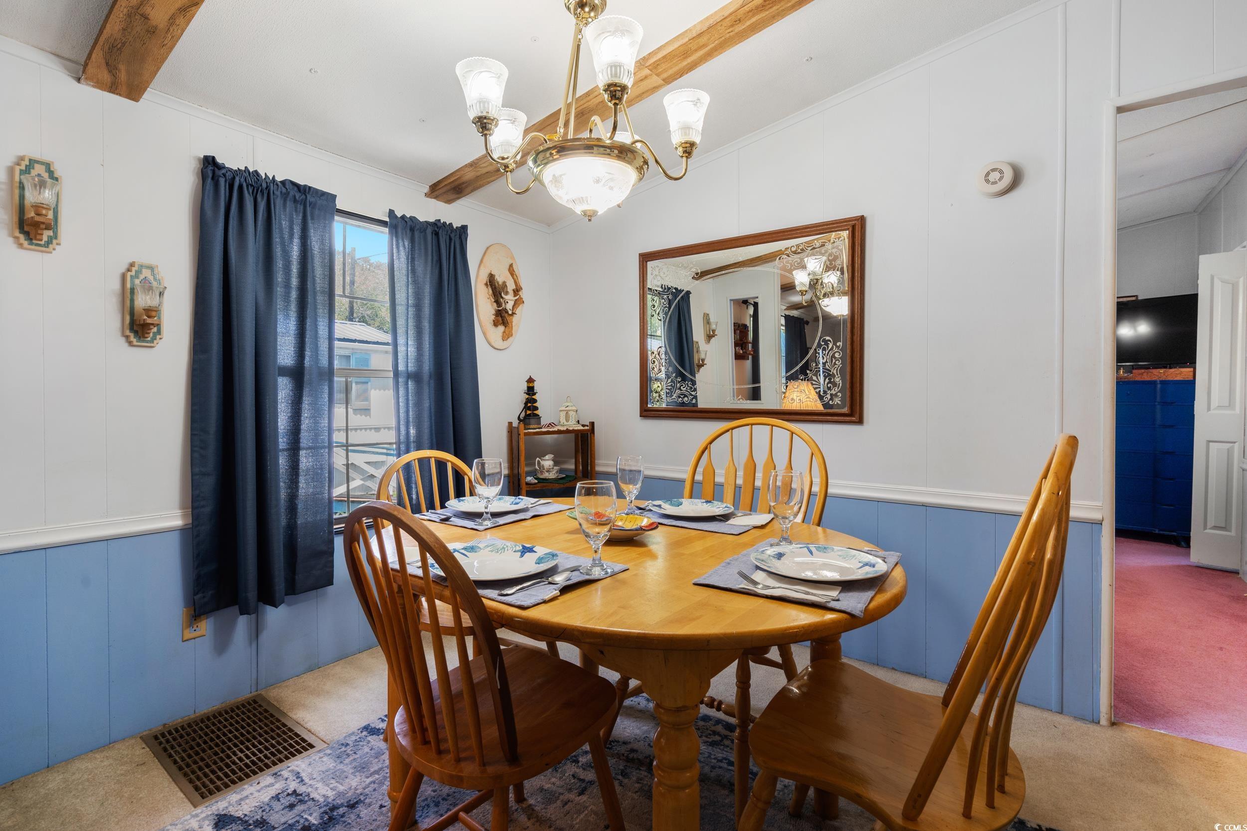 17 Crooked Island Circle Murrells Inlet, SC 29576 - Photo 9 of 39 Dining space with a chandelier, a decorative wall, carpet, and ornamental molding