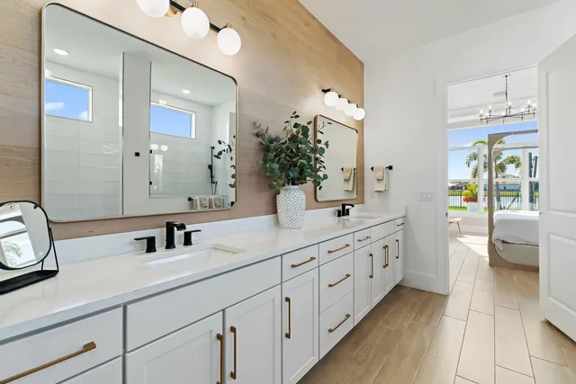 a bathroom with 2 sink and a mirror