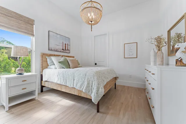 a bedroom with a bed and a painting on the wall