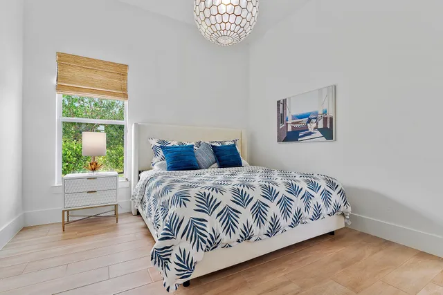 a bedroom with a bed and a painting on the wall