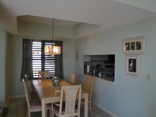 221 Northeast Plantation Road, Unit 415 Jensen Beach, FL 34957 - Photo 3 of 6 a view of a dining room with furniture and window