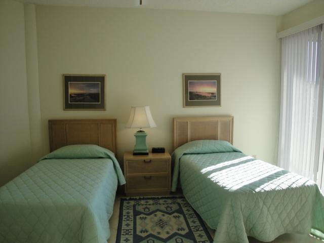 221 Northeast Plantation Road, Unit 415 Jensen Beach, FL 34957 - Photo 6 of 6 a bedroom with a bed and a window