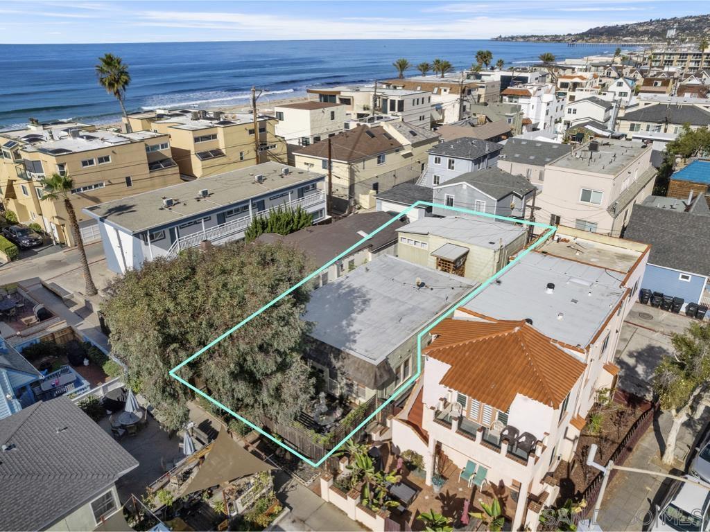 an aerial view of a house with a ocean view
