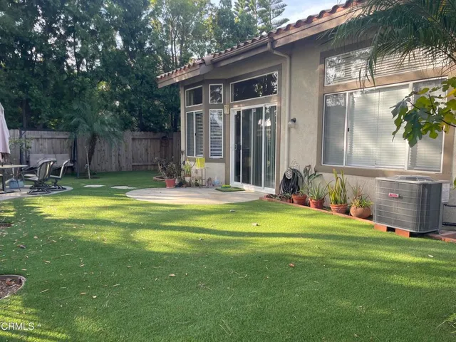 a swimming pool with outdoor seating and yard