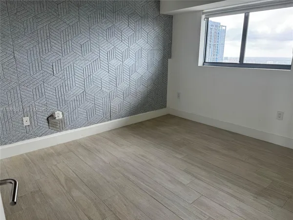 a view of an empty room with a window