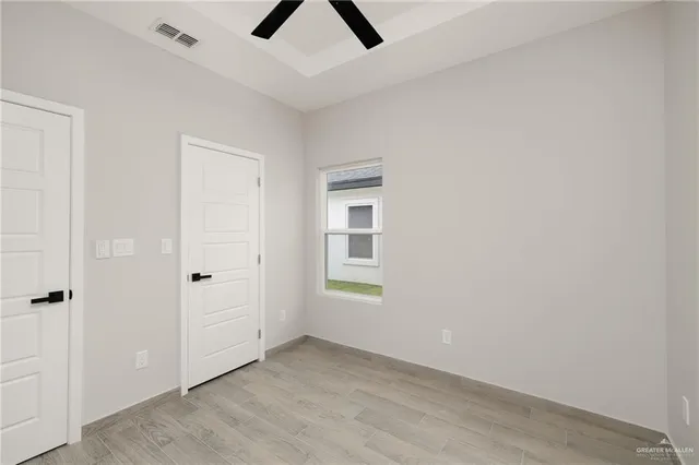 a view of a room with wooden floor and carpet