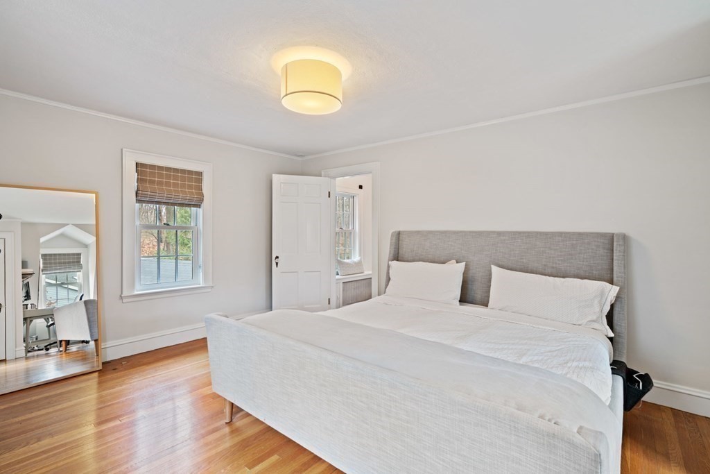 47 Beverly Road Newton, MA 02461 - Photo 11 of 19 a bedroom with a large bed and wooden floor