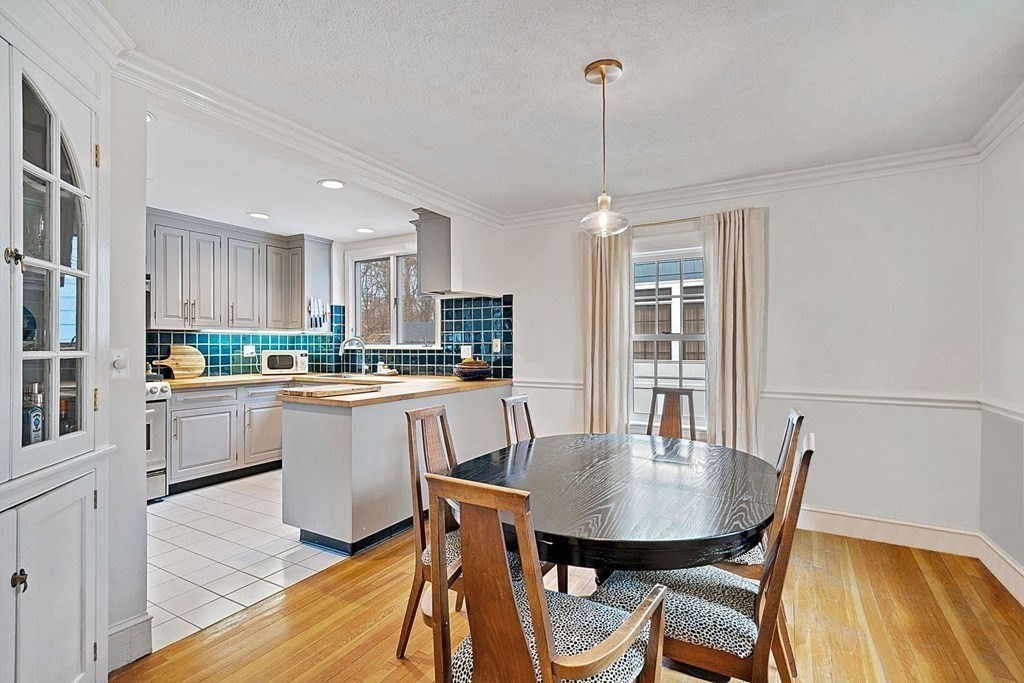 47 Beverly Road Newton, MA 02461 - Photo 3 of 19 a kitchen with a table chairs a sink dishwasher window and cabinets