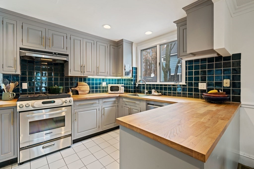 47 Beverly Road Newton, MA 02461 - Photo 4 of 19 a kitchen with kitchen island granite countertop a stove and a sink