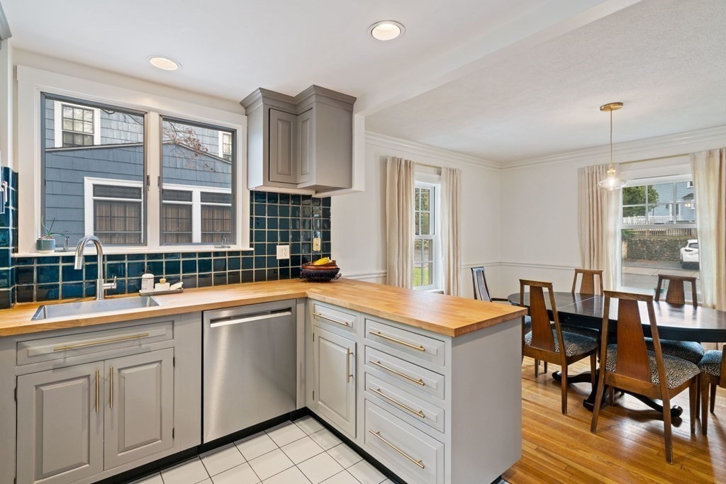 47 Beverly Road Newton, MA 02461 - Photo 5 of 19 a kitchen that has a lot of cabinets in it and wooden floors