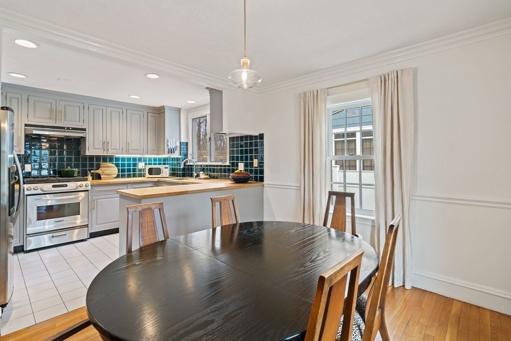 47 Beverly Road Newton, MA 02461 - Photo 8 of 19 a kitchen with a table chairs refrigerator and cabinets
