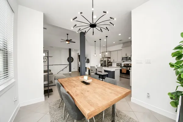 a view of a dining room with furniture and a potted plant