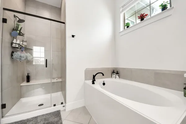 a bathroom with a bathtub and shower