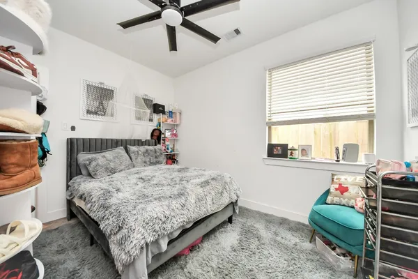 a bedroom with a bed dresser and a window