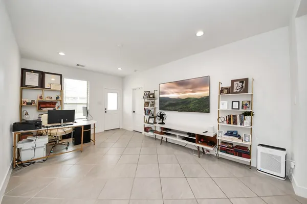 a view of a livingroom with furniture and a flat screen tv