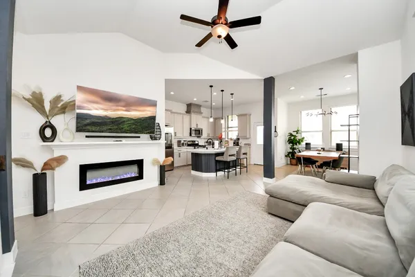 a living room with furniture a fireplace and a flat screen tv