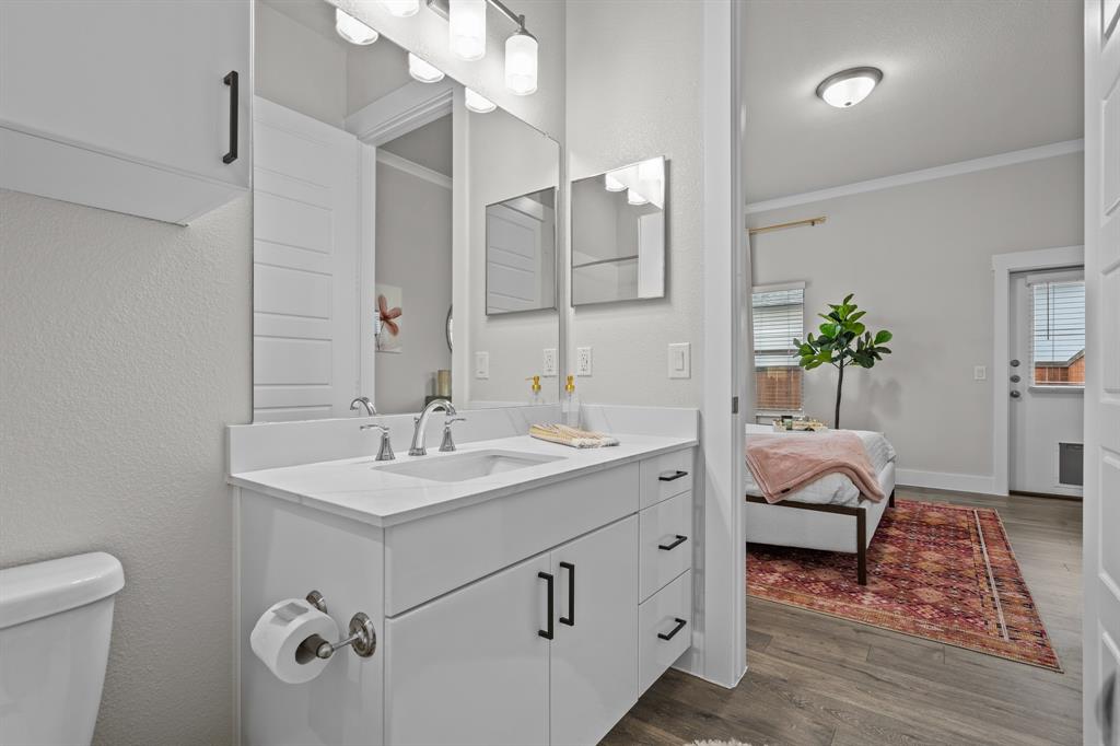 3272 Ganzer Road West Denton, TX 76207 - Photo 15 of 25 a en suite bathroom with a double vanity sink and a mirror
