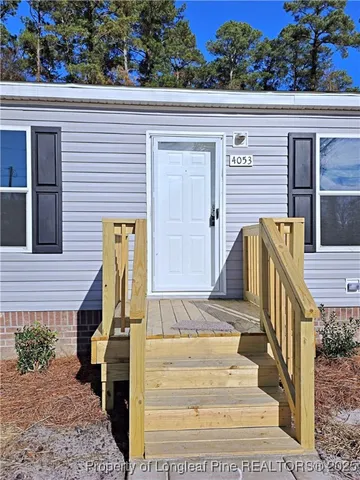 a view of front door of house with stairs