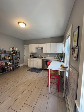 a open kitchen with stainless steel appliances granite countertop a stove and a refrigerator