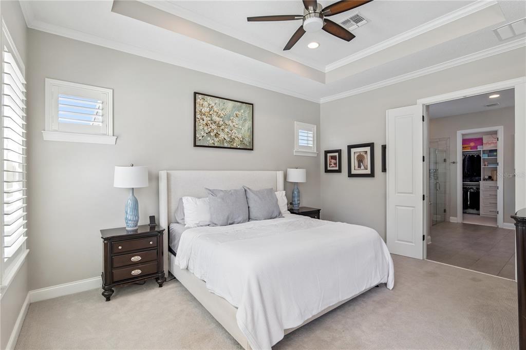 352 Moonbeam Loop Oviedo, FL 32765 - Photo 17 of 64 a bedroom with a bed and a chandelier