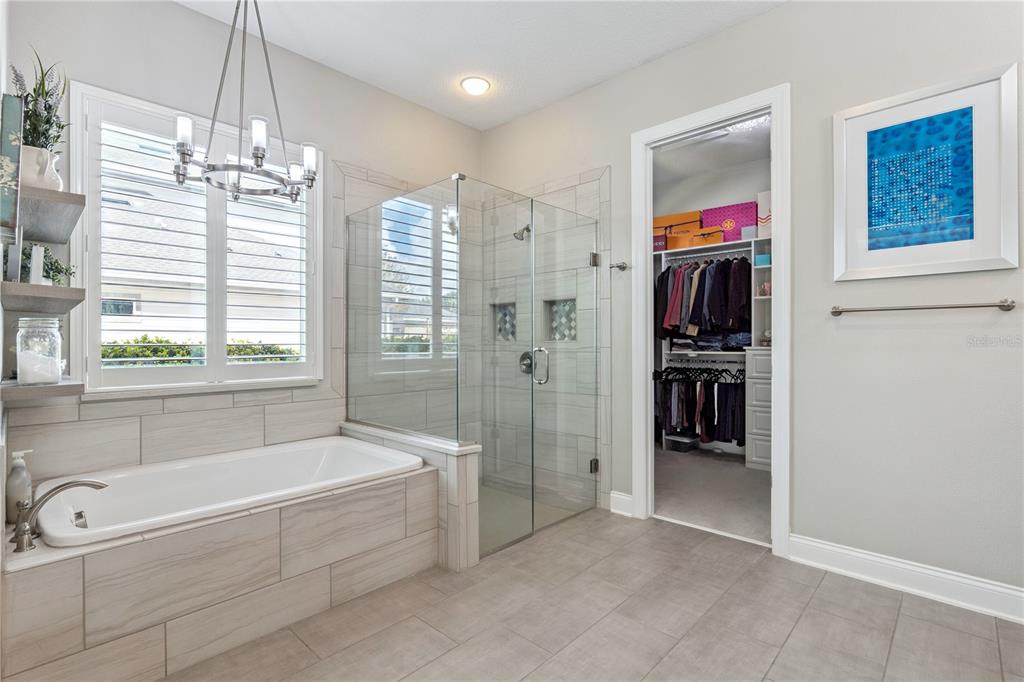 352 Moonbeam Loop Oviedo, FL 32765 - Photo 21 of 64 a spacious bathroom with a tub a window and a shower
