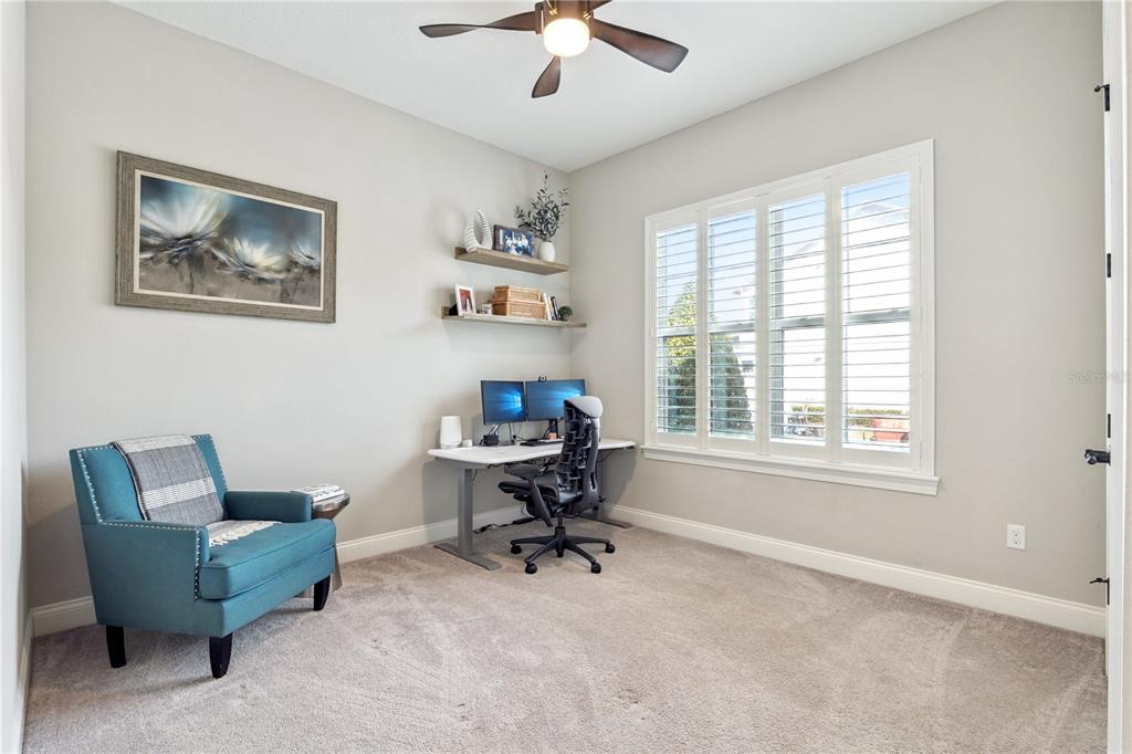 352 Moonbeam Loop Oviedo, FL 32765 - Photo 25 of 64 a view of a workspace with furniture and a window
