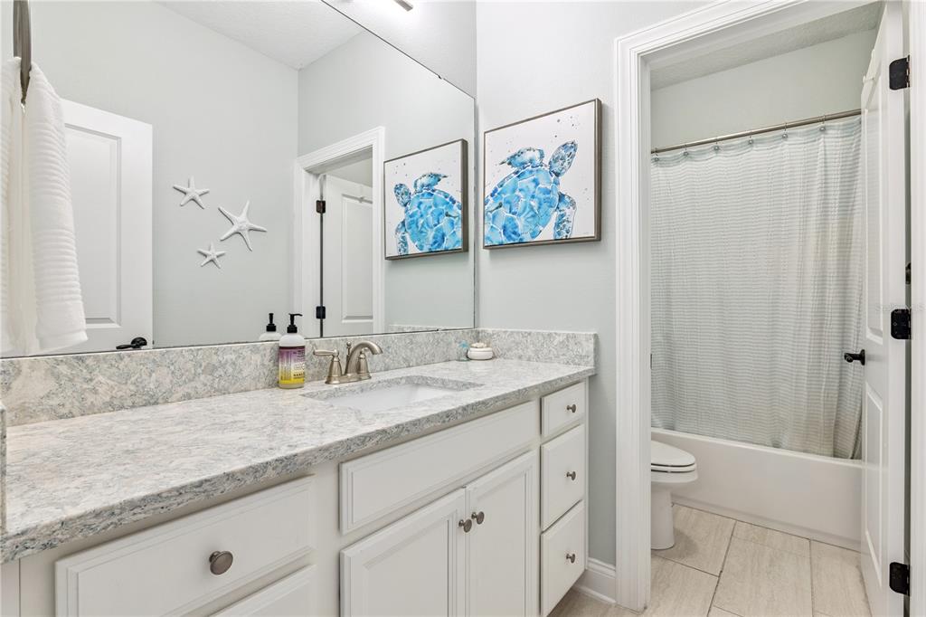 352 Moonbeam Loop Oviedo, FL 32765 - Photo 33 of 64 a bathroom with a granite countertop sink a mirror and a shower