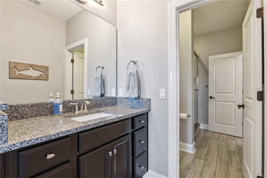 352 Moonbeam Loop Oviedo, FL 32765 - Photo 35 of 64 a bathroom with a granite countertop sink and a mirror