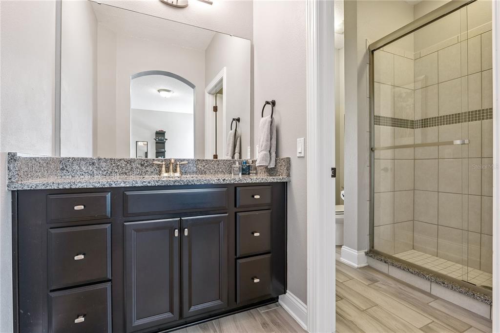 352 Moonbeam Loop Oviedo, FL 32765 - Photo 37 of 64 a bathroom with a granite countertop sink two mirror and shower