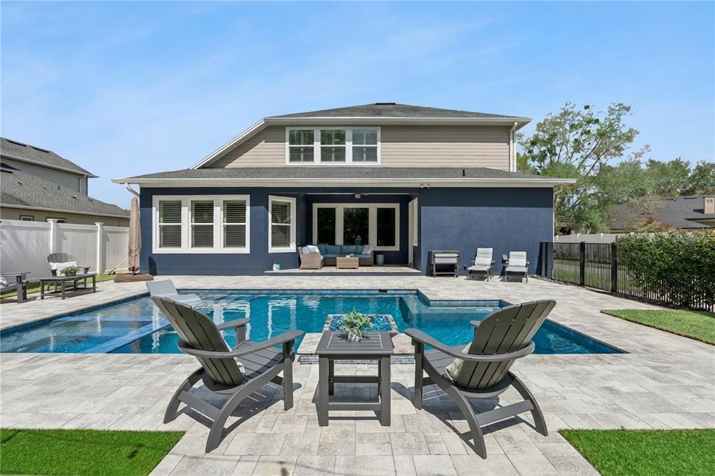 352 Moonbeam Loop Oviedo, FL 32765 - Photo 43 of 64 a front view of a house with swimming pool and porch