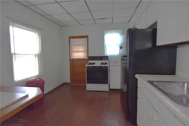 a kitchen with a refrigerator and a stove top oven