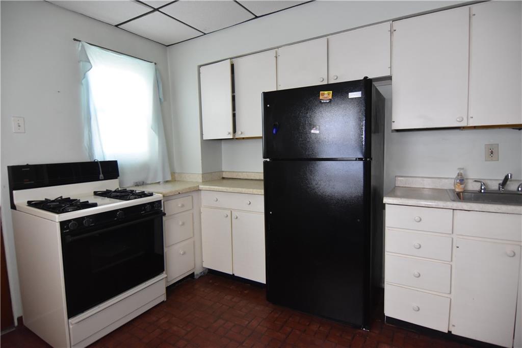 613 East 19th Avenue Homestead, PA 15120 - Photo 15 of 33 a kitchen with a stove and a refrigerator