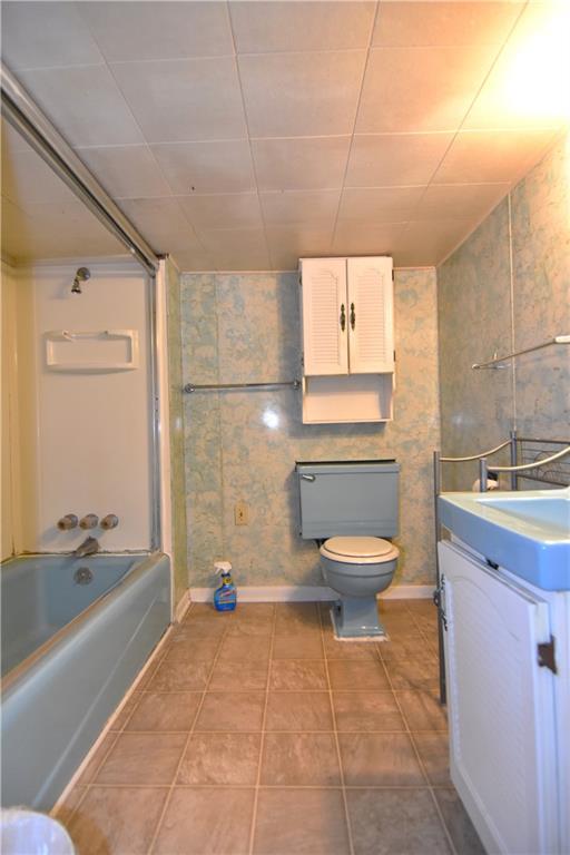 613 East 19th Avenue Homestead, PA 15120 - Photo 26 of 33 a bathroom with a granite countertop toilet a sink and bathtub
