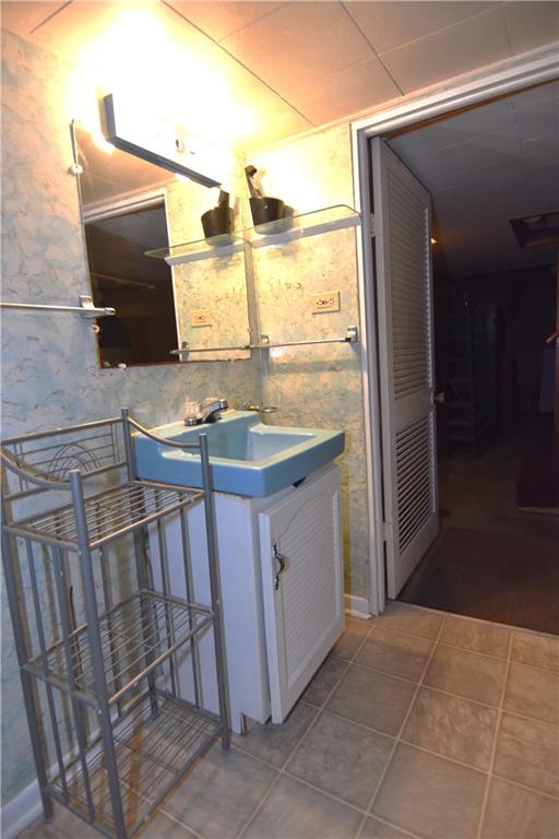 613 East 19th Avenue Homestead, PA 15120 - Photo 27 of 33 a bathroom with a sink and a mirror