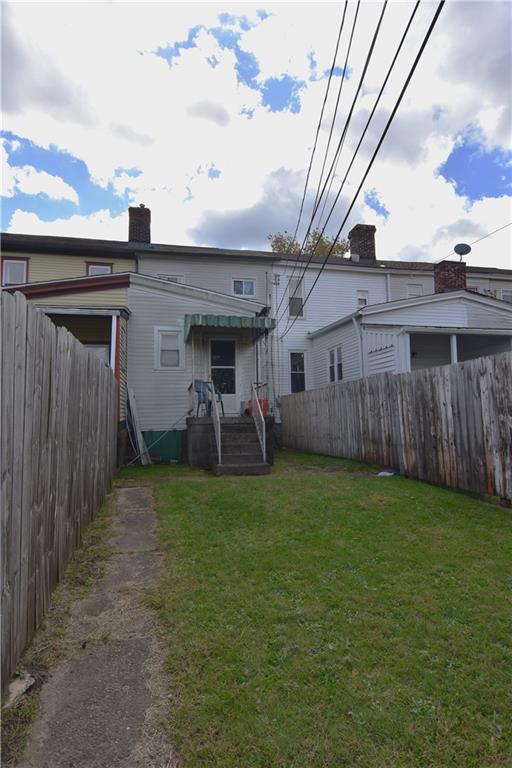 613 East 19th Avenue Homestead, PA 15120 - Photo 31 of 33 a view of a backyard with plants and wooden fence