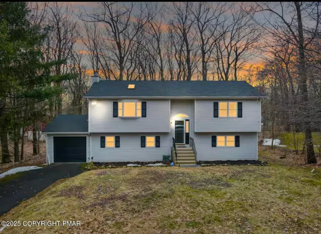 a front view of a house with a yard