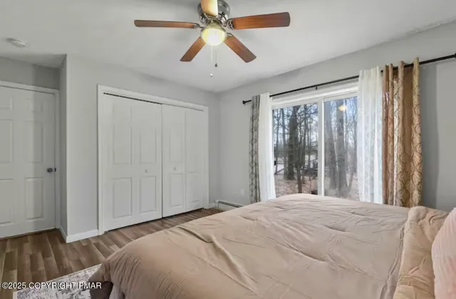 a bedroom with a bed and a chandelier fan