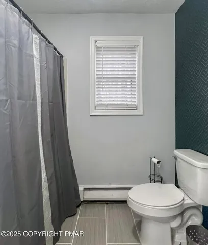 a white toilet sitting next to a small sink