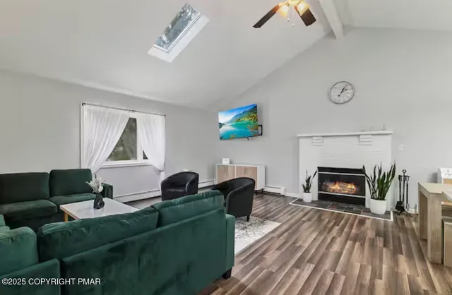 a living room with furniture and a fireplace