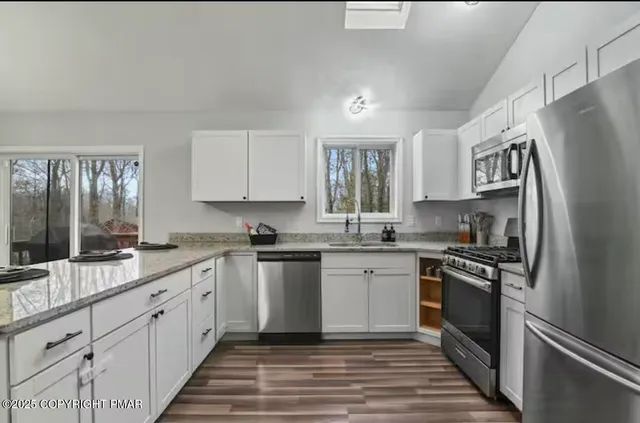 a kitchen with a sink stove and refrigerator
