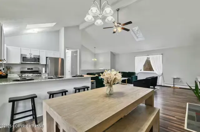 a view of a dining room and kitchen with a table chairs a workspace