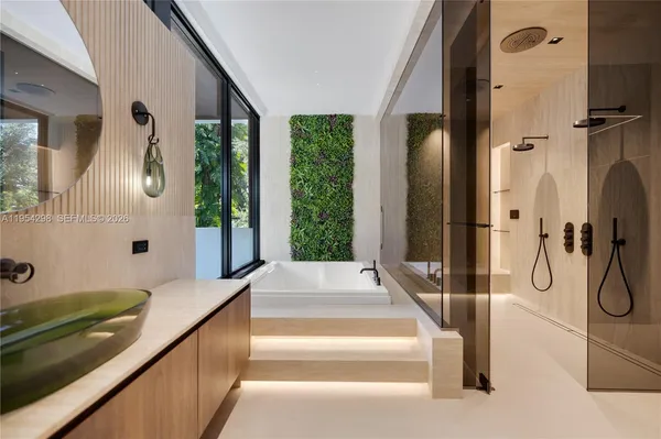 a spacious bathroom with a tub and large windows
