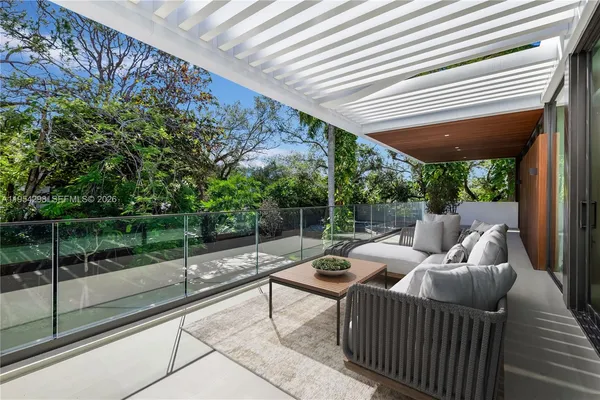 a view of a patio with couches next to a yard