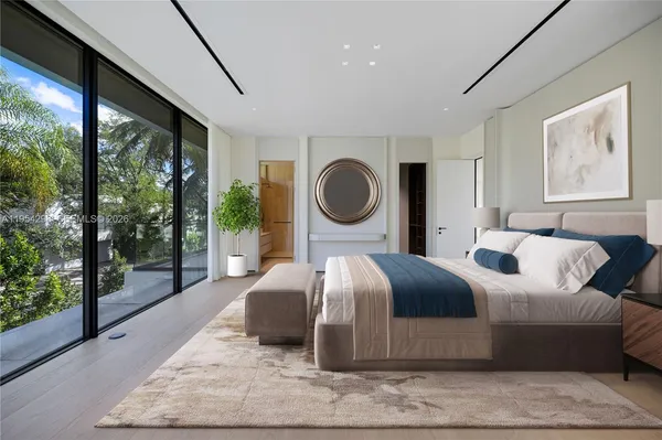 a bedroom with a large bed and a large window