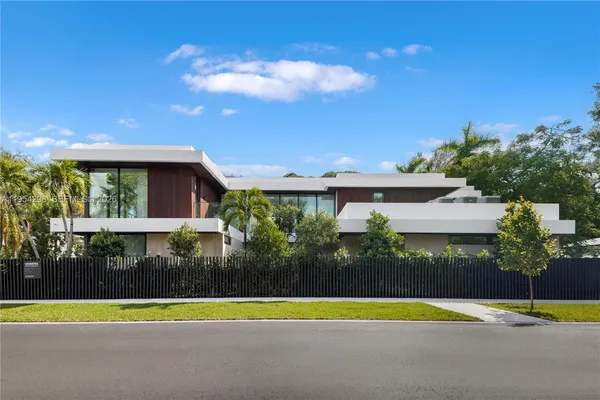 a view of a house with a swimming pool and a yard