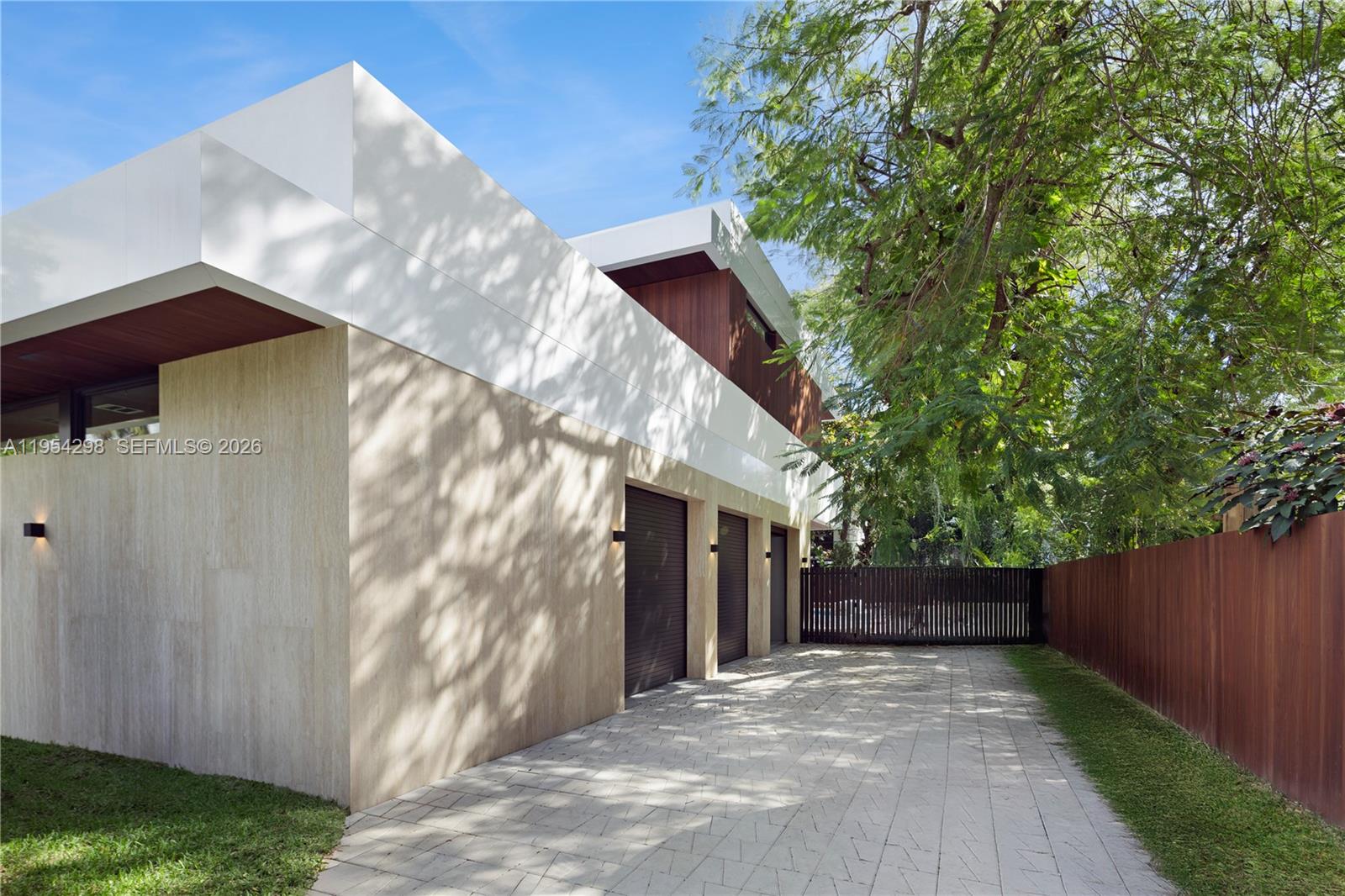 3210 Coacoochee Street Miami, FL 33133 - Photo 27 of 29 a front view of a house with a yard and garage