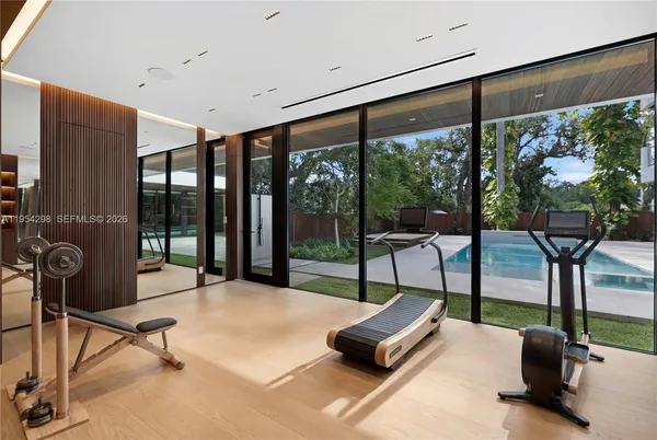a living room with glass door and furniture