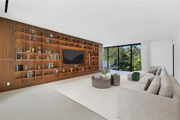 a living room with furniture a flat screen tv and a large window