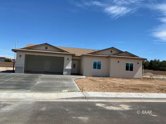 1037 Ocean Avenue Ridgecrest, CA 93555 - Photo 1 of 12 a front view of a house with a yard and garage