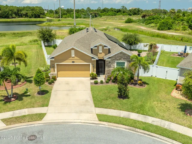 an aerial view of a house with a yard basket ball court and outdoor seating